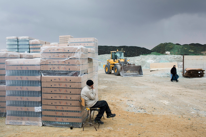 A worker takes a cigarette break.